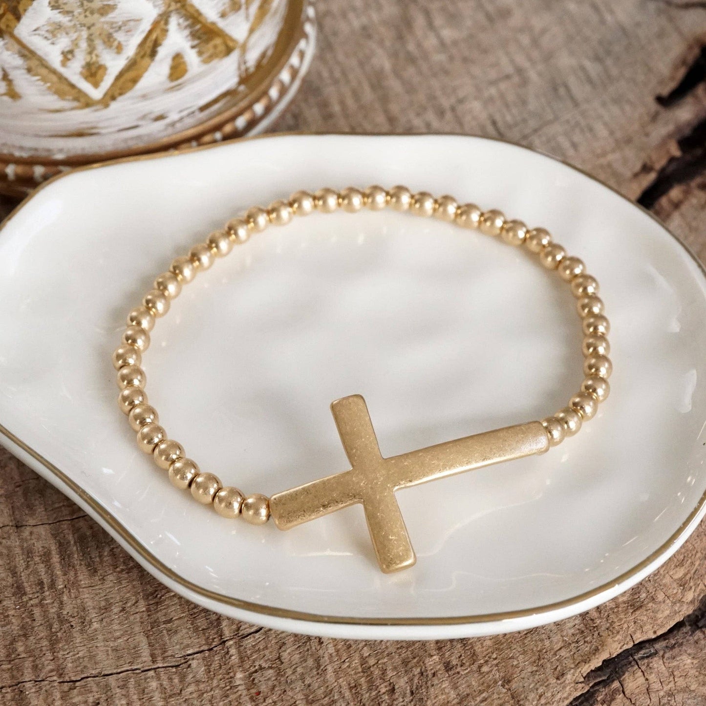 Cross Stretchy Bracelet in Worn Gold tone