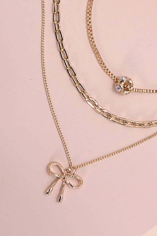 MULTI LAYER PEARL BOW CAHRMNECKLACE